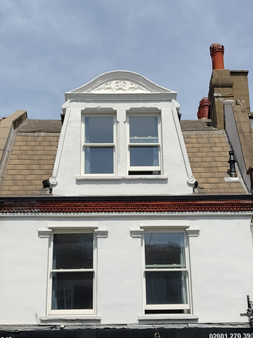 Figure 60: Detail of the dormer and pediment to no.246 Upper Richmond Road West. This is the best preserved of the four at nos.246 - 252 as it has retained the pediment and detail, as well as the cornice below